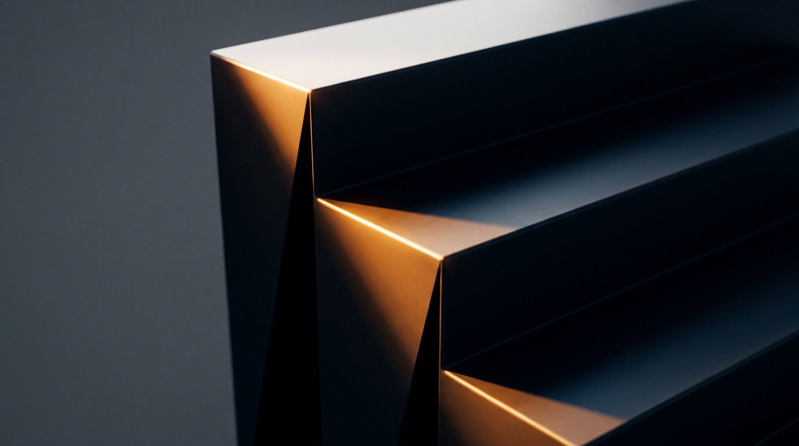 Folded dark panels forming clean geometric steps, one leading edge catching warm light.